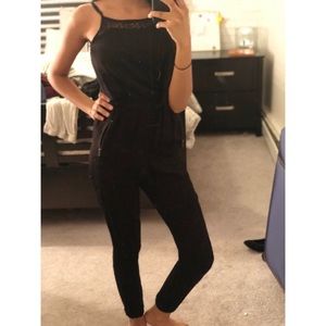 Black jumpsuit with zipper pockets and lace neck